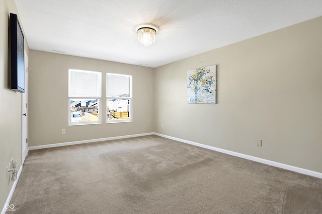 spare room featuring carpet floors