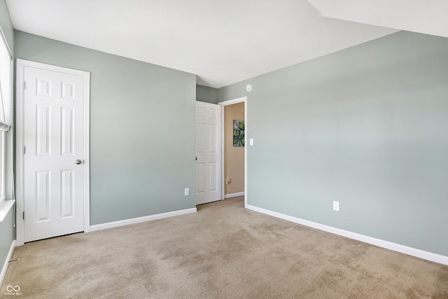 unfurnished room with light carpet