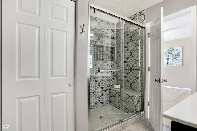 bathroom featuring vanity, a textured ceiling, and walk in shower