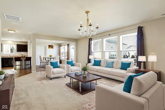 living room featuring plenty of natural light and a notable chandelier