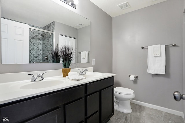 bathroom with vanity, toilet, and a shower with shower door