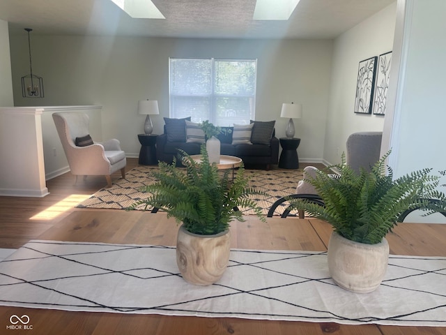 living room featuring a skylight and hardwood / wood-style floors