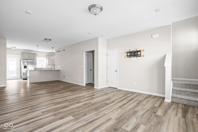 unfurnished living room featuring hardwood / wood-style floors