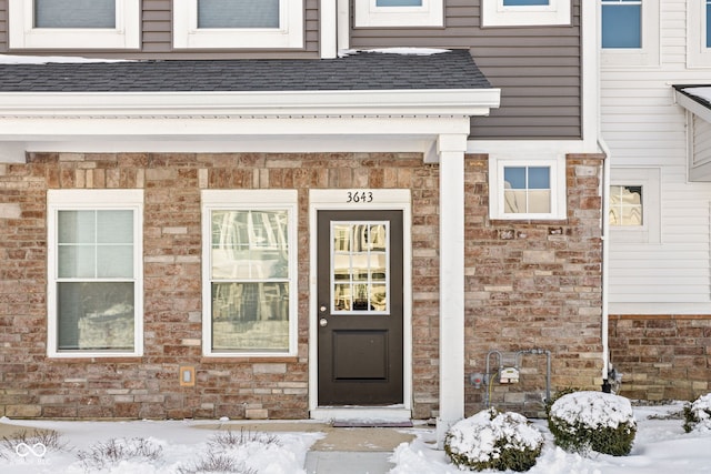 view of snow covered property entrance