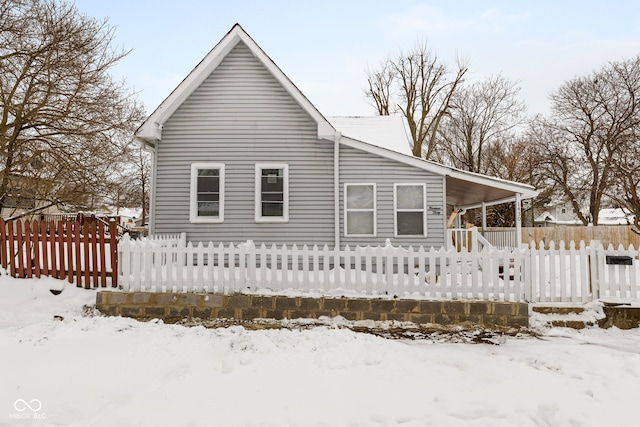 snow covered property with a porch