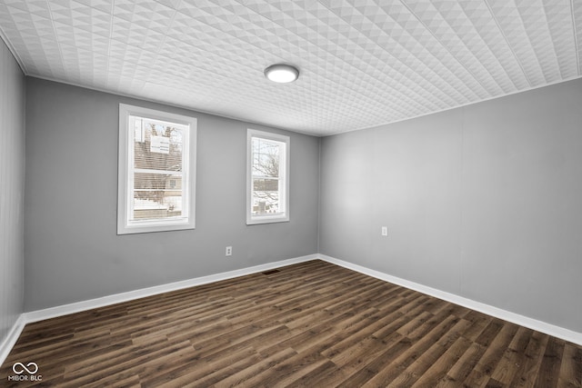 spare room featuring dark hardwood / wood-style floors