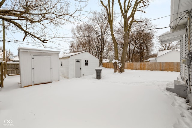 snowy yard with a storage unit