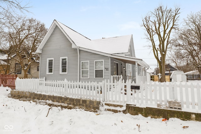 view of snow covered rear of property