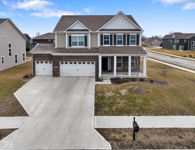 view of front of home with a porch, a front lawn, brick siding, and board and batten siding