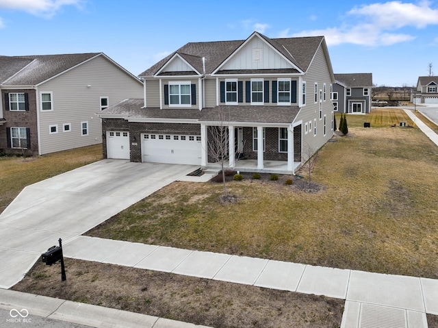 view of front of house with driveway, a front yard, board and batten siding, and brick siding