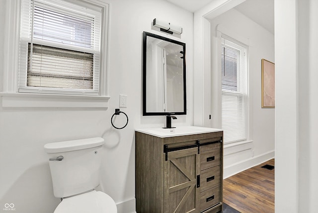 bathroom with vanity, hardwood / wood-style floors, and toilet