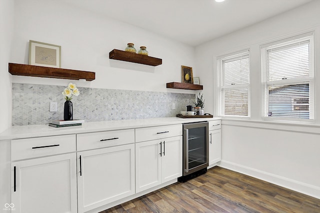 kitchen with white cabinetry, decorative backsplash, dark wood-type flooring, and beverage cooler