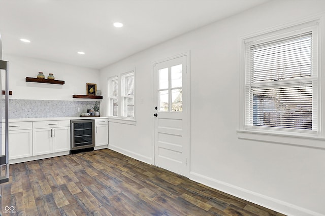 kitchen featuring wine cooler, dark hardwood / wood-style flooring, and white cabinets