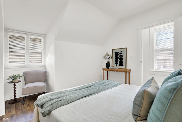 bedroom featuring hardwood / wood-style floors and vaulted ceiling