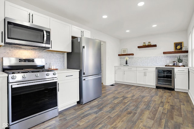 kitchen featuring tasteful backsplash, dark hardwood / wood-style flooring, stainless steel appliances, beverage cooler, and white cabinets