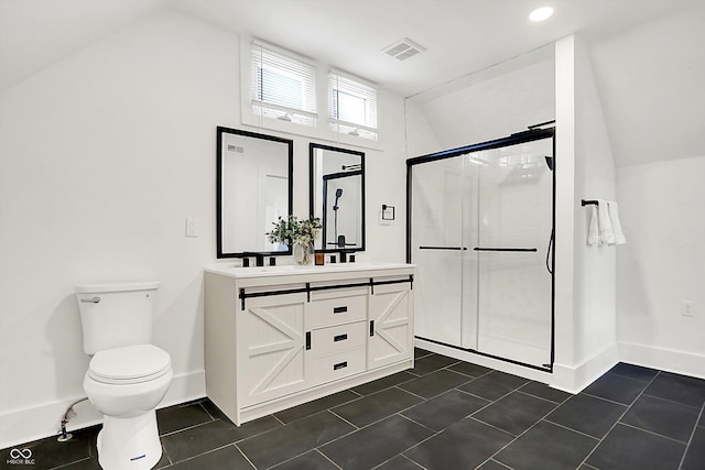 bathroom with tile patterned flooring, toilet, vanity, and walk in shower