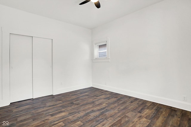 empty room featuring ceiling fan and dark hardwood / wood-style flooring