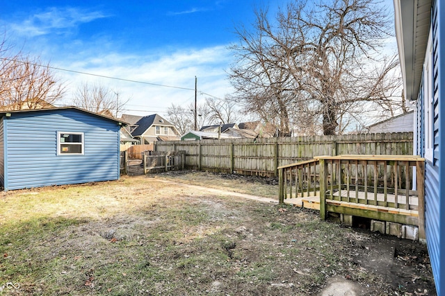 view of yard with a wooden deck and an outdoor structure