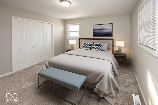 carpeted bedroom featuring a closet