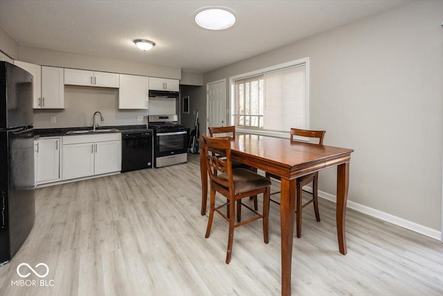 kitchen featuring white cabinetry, sink, black appliances, and light hardwood / wood-style flooring