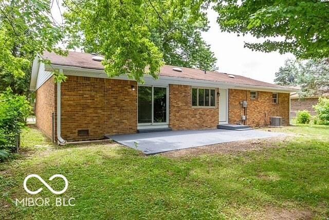 back of house featuring a lawn, central AC, and a patio