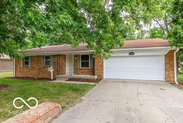 ranch-style home with a front yard, a porch, and a garage