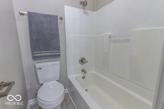 bathroom with shower / tub combination, toilet, and wood-type flooring