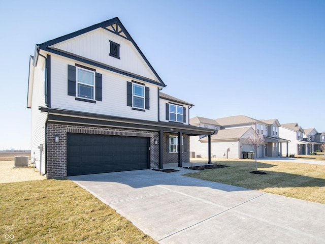 view of front of house with a front yard, driveway, brick siding, a garage, and a residential view