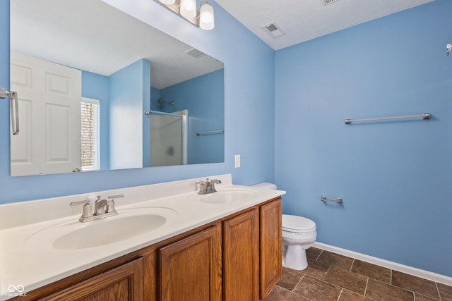 bathroom with vanity, toilet, and an enclosed shower