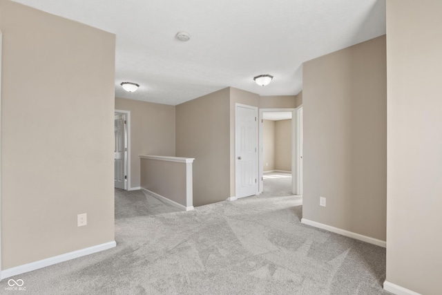 spare room featuring light colored carpet