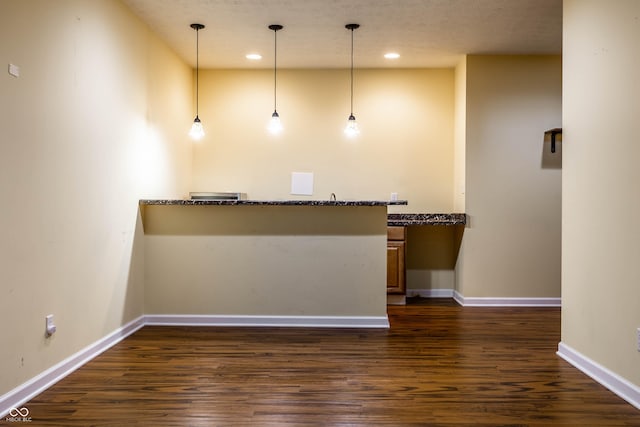 interior space with recessed lighting, pendant lighting, baseboards, and dark wood-style flooring