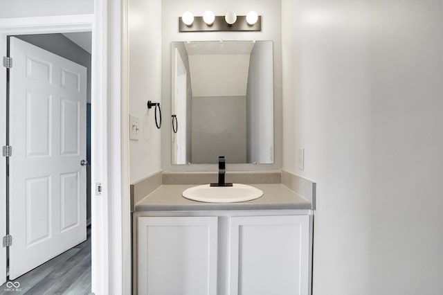 bathroom featuring hardwood / wood-style flooring and vanity