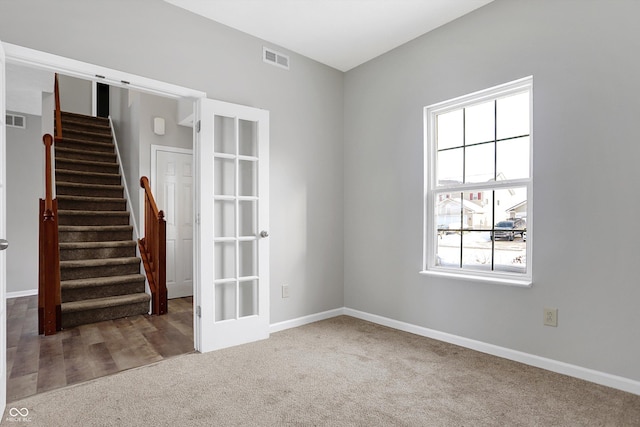 carpeted empty room with french doors