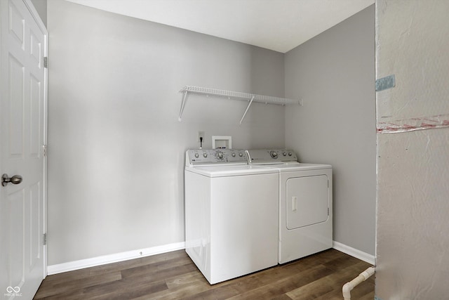 laundry area with dark hardwood / wood-style flooring and washer and dryer