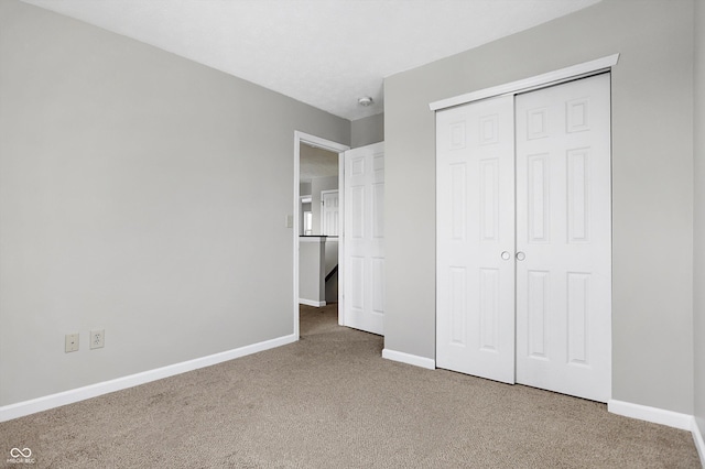 unfurnished bedroom with carpet and a closet