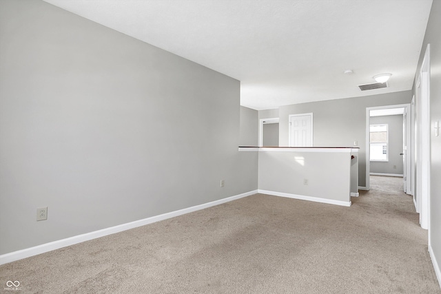 empty room featuring light colored carpet