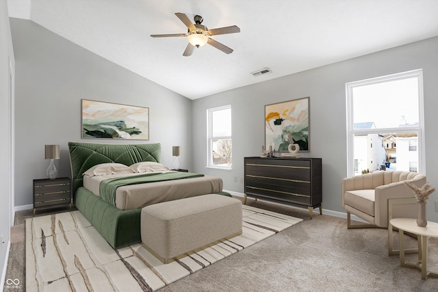 carpeted bedroom featuring ceiling fan and vaulted ceiling