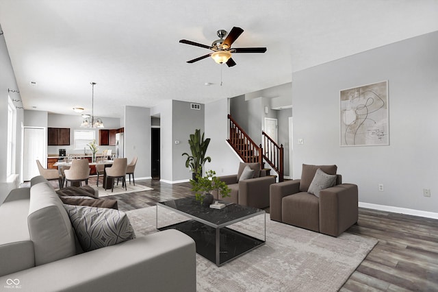 living room featuring sink, ceiling fan with notable chandelier, and hardwood / wood-style flooring