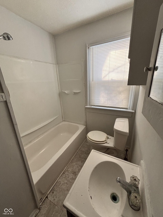 full bathroom featuring vanity, shower / bathing tub combination, a textured ceiling, and toilet