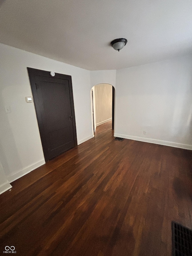 spare room with dark hardwood / wood-style floors