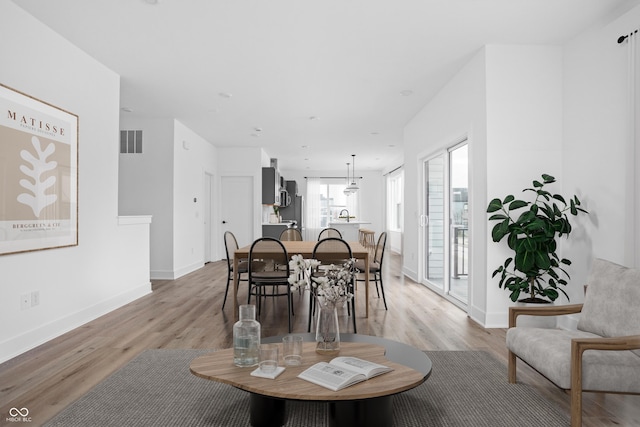 dining space with light wood-type flooring