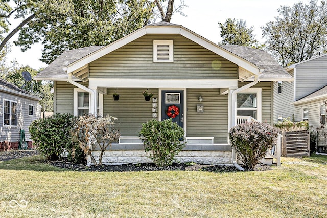 bungalow-style house with covered porch and a front yard