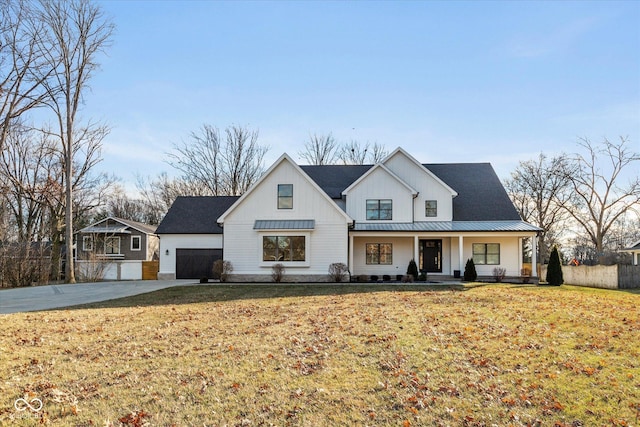 modern inspired farmhouse featuring covered porch and a front yard