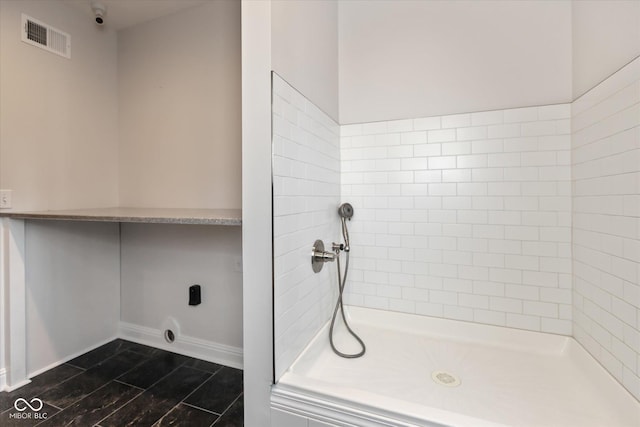 bathroom with a tile shower