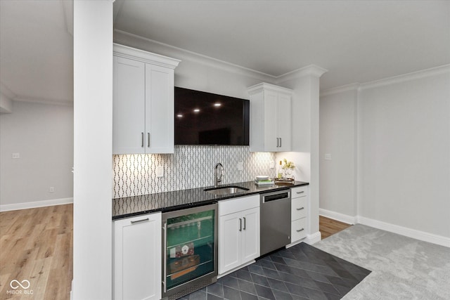 kitchen with white cabinets, stainless steel dishwasher, beverage cooler, and sink