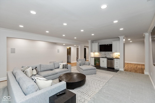 living room with wine cooler and ornamental molding