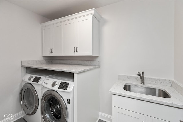 washroom with sink, cabinets, and independent washer and dryer