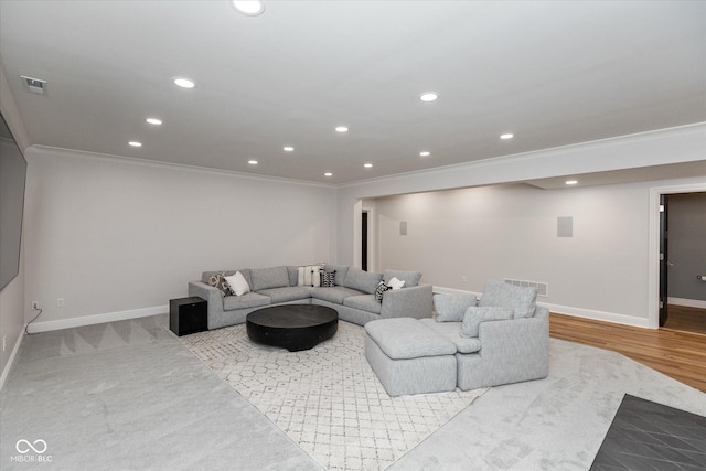 living room featuring ornamental molding and light carpet