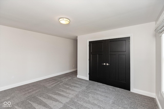 unfurnished bedroom featuring carpet floors and a closet