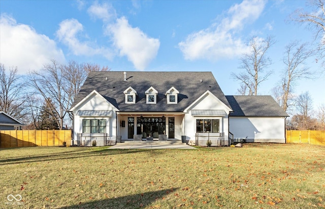 rear view of house featuring a patio area and a lawn